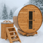Cedar barrel sauna and matching cedar cold plunge set on a snowy winter landscape, showcasing Saunaspa’s outdoor wellness products.