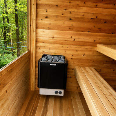 Moderna Cedar Sauna Interior with Harvia Electric Heater | SaunaSpa Interior of a Moderna cedar sauna featuring a wall-mounted Harvia electric sauna heater, wooden benches, and a large window overlooking the forest.